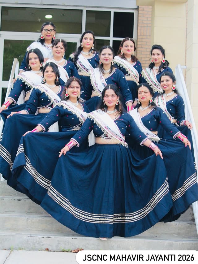 Chani's dance group in navy blue lehengas, posing on steps at JSCNC Mahavir Jayanti 2026