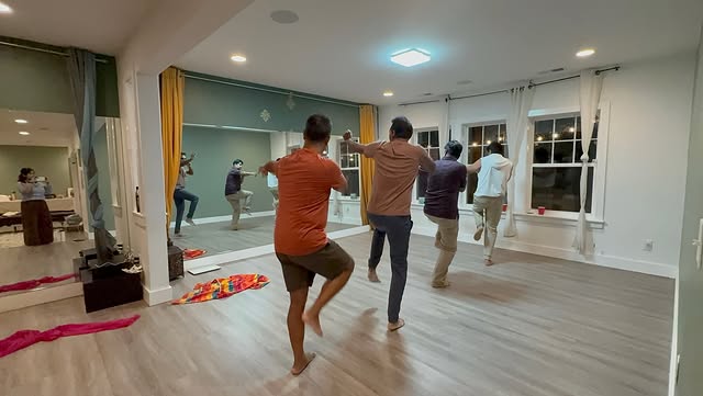 Men practicing a dance routine in a studio